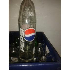 Envases de vidrio vacios y cajones Pepsi y Coca Cola de 1.25 Lts